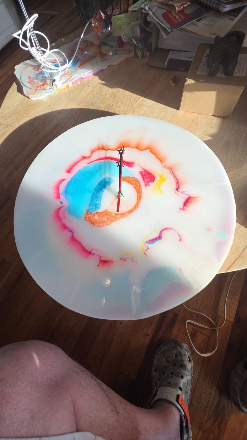 Round resin clock with colorful ink swirls