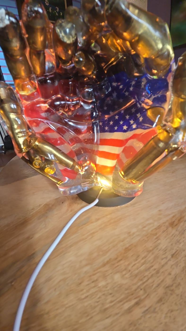 Cupped resin hands with an American flag inside on a light-up base