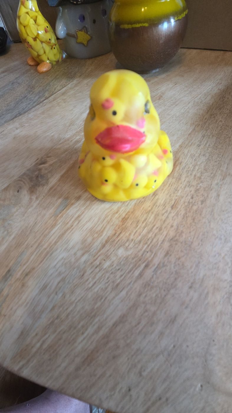 Yellow resin duck filled with tiny ducks
